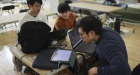 Juniors Si Ming Zhou, Siah Wee Hung, and Khoo Yong Hui working on their hackathon project